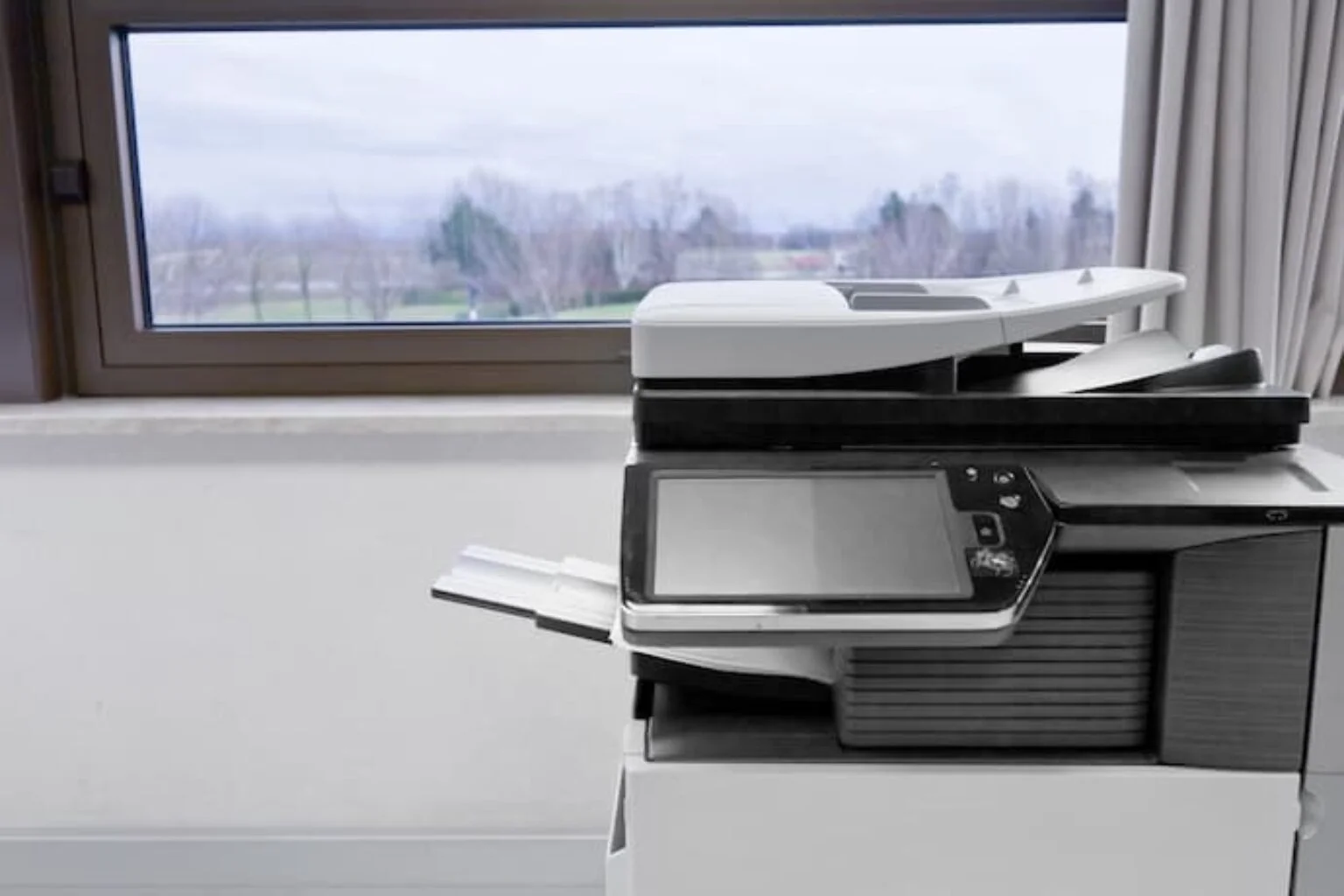 Impressora a3 em mesa de escritório.